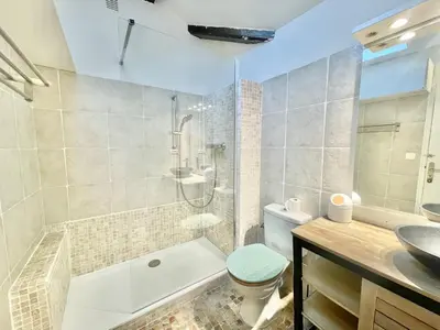 a bathroom with a tub and a toilet and a sink at Carré d'or Duplex, by Welcome to Cannes in Cannes
