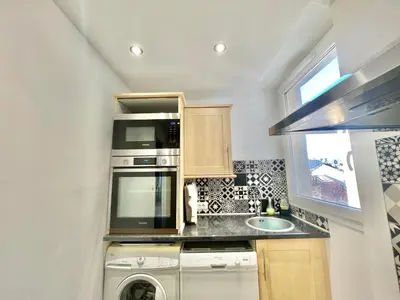 a small kitchen with a washer and a microwave at Carré d'or Duplex, by Welcome to Cannes in Cannes