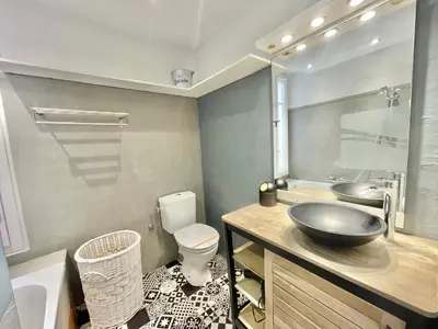 a bathroom with a sink and a toilet and a tub at Carré d'or Duplex, by Welcome to Cannes in Cannes
