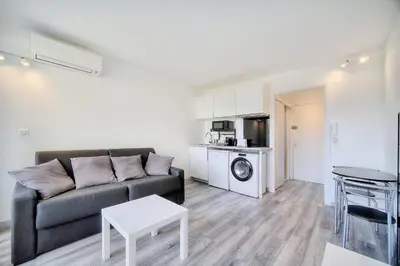 a living room with a couch and a table at IMMOGROOM - Pool - Terrace - Parking - Air conditioning - NO WIFI in Cannes
