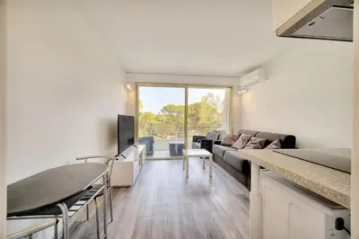 a living room with a couch and a table at IMMOGROOM - Pool - Terrace - Parking - Air conditioning - NO WIFI in Cannes
