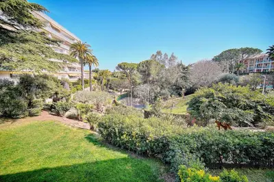 a view of a park with trees and a building at IMMOGROOM - Pool - Terrace - Parking - Air conditioning - NO WIFI in Cannes