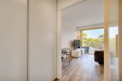 a living room with a sliding door leading to a dining room at IMMOGROOM - Pool - Terrace - Parking - Air conditioning - NO WIFI in Cannes