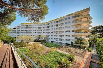 an apartment building with a pathway in front of it at IMMOGROOM - Pool - Terrace - Parking - Air conditioning - NO WIFI in Cannes