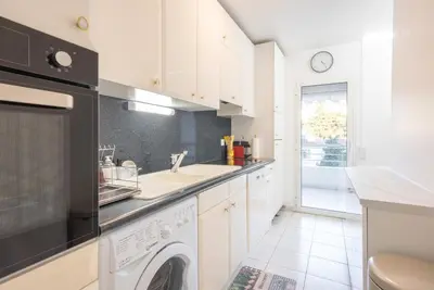 a kitchen with a washing machine and a sink at Le Parisien by Winsome Destination in Cannes