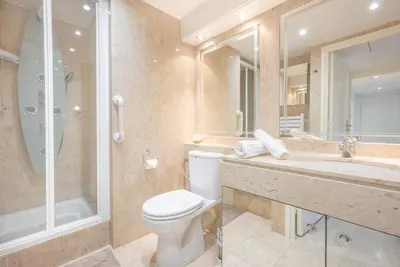 a bathroom with a toilet and a shower and a sink at Le Parisien by Winsome Destination in Cannes