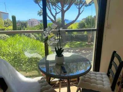 a glass table and chairs in front of a window at The Sun Paradise Dream in Cannes
