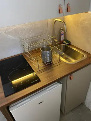 a kitchen with a sink and a stove and a sink at Mansarde Cannes in Cannes