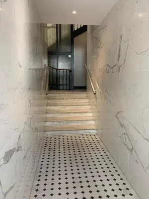 a hallway with a black and white tiled floor at Mansarde Cannes in Cannes