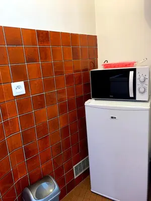 a microwave sitting on top of a refrigerator at Cannes center parking very calm California neighborhood in Cannes
