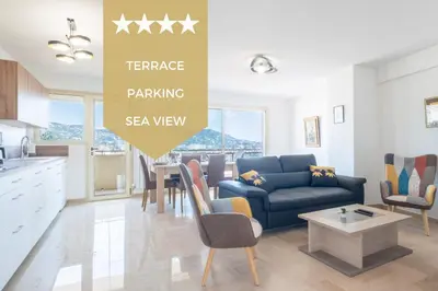 a living room with a blue couch and a table at 3-Br apartment near downtown Cannes Sea view parking in Cannes