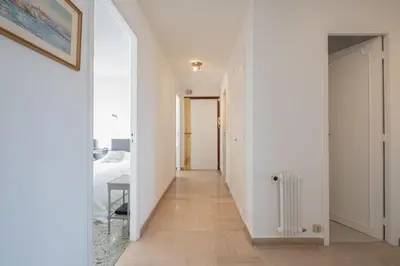 a hallway of a house with white walls and a radiator at 3-Br apartment near downtown Cannes Sea view parking in Cannes