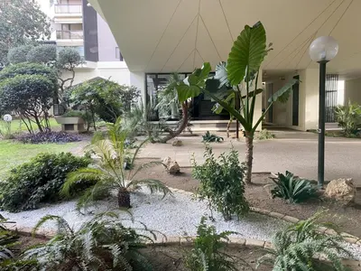 a courtyard with plants in front of a building at jardins croisette PRES CROISETTE in Cannes