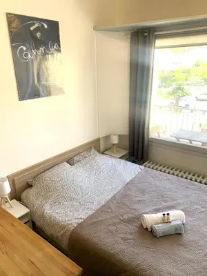 a bedroom with a bed with a towel on it at Cannes center terrace AC Wifi 200 m from sea behind Martinez in Cannes