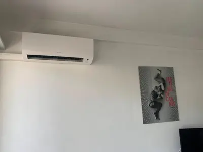 a wall mounted air conditioner and a poster on a wall at Cannes center terrace AC Wifi 200 m from sea behind Martinez in Cannes