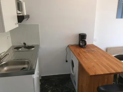 a small kitchen with a sink and a washing machine at Cannes center terrace AC Wifi 200 m from sea behind Martinez in Cannes