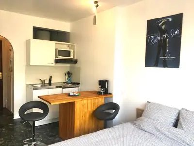a room with a bed and a table with two chairs at Cannes center terrace AC Wifi 200 m from sea behind Martinez in Cannes