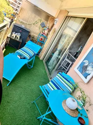 a patio with a table and chairs on a lawn at Luxurious Studio in Cannes 450m from sea with Terrace and Air Conditioning and private Parking in Cannes