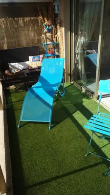 two blue chairs and a table on a patio at Luxurious Studio in Cannes 450m from sea with Terrace and Air Conditioning and private Parking in Cannes