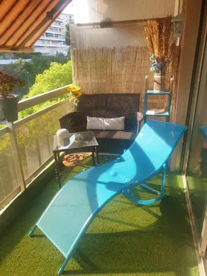 a balcony with a blue table and a chair at Luxurious Studio in Cannes 450m from sea with Terrace and Air Conditioning and private Parking in Cannes