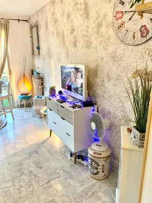 a room with a desk with a tv and a fan at Luxurious Studio in Cannes 450m from sea with Terrace and Air Conditioning and private Parking in Cannes