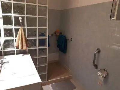 a bathroom with a shower and a sink and a shower at SPACIEUX STUDIO 37m2 - Terrasse VUE MER in Cannes