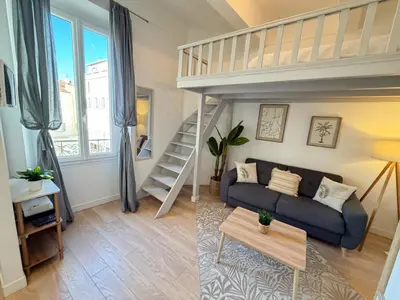 a living room with a couch and a loft bed at Beautiful studio Cannes Center in Cannes