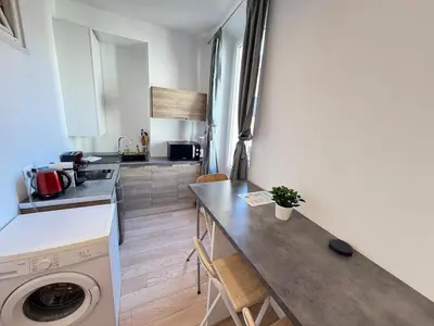 a kitchen with a counter and a washing machine at Beautiful studio Cannes Center in Cannes