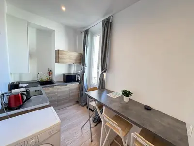 a kitchen with a table and a counter top at Beautiful studio Cannes Center in Cannes