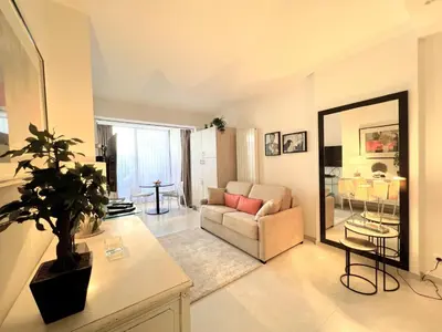 a living room with a couch and a mirror at Marema appartement, by Welcome to Cannes in Cannes
