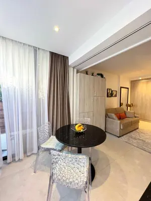 a dining room with a black table and chairs at Marema appartement, by Welcome to Cannes in Cannes