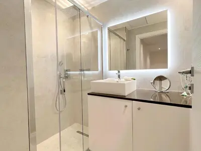 a white bathroom with a sink and a shower at Marema appartement, by Welcome to Cannes in Cannes