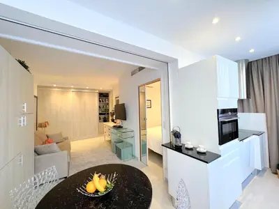 a kitchen and a living room with a table at Marema appartement, by Welcome to Cannes in Cannes