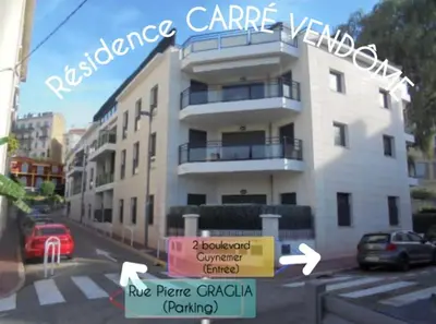 a large white building with a sign in front of it at CANNES: Appartement Cosy à 2 pas de la Croisette in Cannes