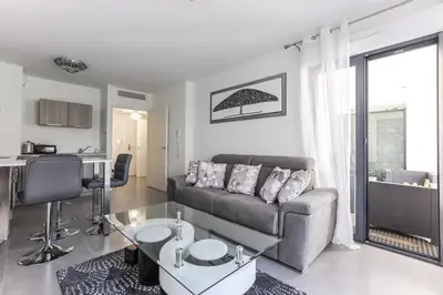 a living room with a couch and a table at CANNES: Appartement Cosy à 2 pas de la Croisette in Cannes