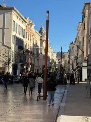 a group of people walking down a city street at CANNES: Appartement Cosy à 2 pas de la Croisette in Cannes