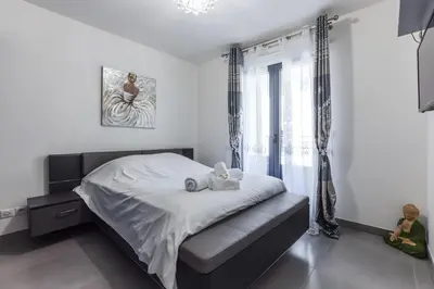 a bedroom with a bed with two stuffed animals on it at CANNES: Appartement Cosy à 2 pas de la Croisette in Cannes