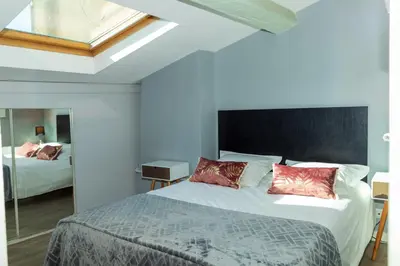 a bedroom with a large bed with red pillows at Croisette 1 min palais des festival/ plages /FIF in Cannes