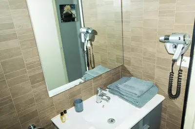 a bedroom with two beds and a mirror in it at Croisette 1 min palais des festival/ plages /FIF in Cannes