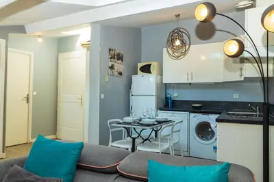 a living room with a couch and a table at Croisette 1 min palais des festival/ plages /FIF in Cannes