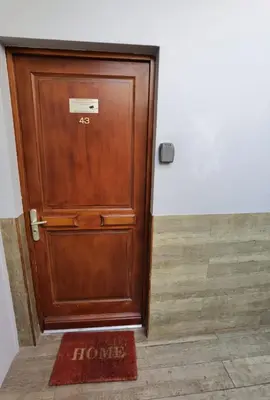 a wooden door in a room with a welcome mat at Croisette 1 min palais des festival/ plages /FIF in Cannes
