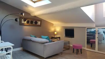 a living room with a couch and a tv at Croisette 1 min palais des festival/ plages /FIF in Cannes