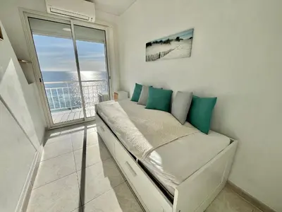 a bedroom with a bed and a large window at Louise appartement, by Welcome to Cannes in Cannes