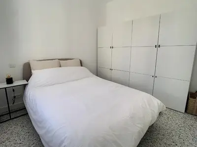 a bedroom with a white bed and white cabinets at 2 bedroom Majestic, 1 min to the Croisette 357 in Cannes