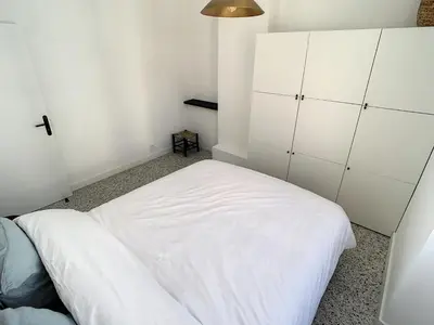 a bedroom with a white bed and white cabinets at 2 bedroom Majestic, 1 min to the Croisette 357 in Cannes