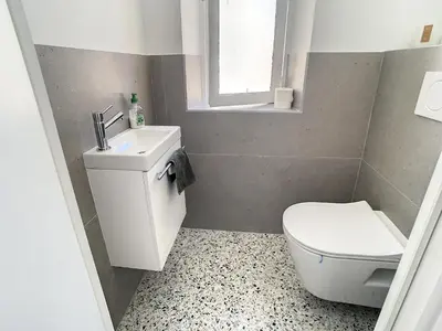 a bathroom with a toilet and a sink and a window at 2 bedroom Majestic, 1 min to the Croisette 357 in Cannes