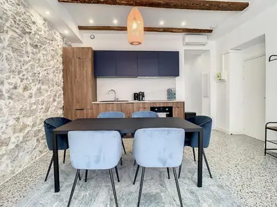a kitchen and dining room with a black table and chairs at 2 bedroom Majestic, 1 min to the Croisette 357 in Cannes