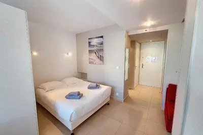 a bedroom with a bed with towels on it at HENRI CAMILLE REAL ESTATE - Rouaze 2 -Studio à 50m center in Cannes