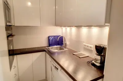 a small kitchen with a sink and a counter at HENRI CAMILLE REAL ESTATE - Rouaze 2 -Studio à 50m center in Cannes