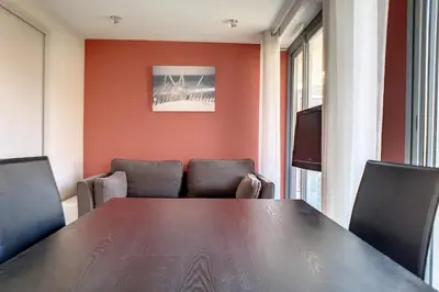 a conference room with a wooden table and chairs at HENRI CAMILLE REAL ESTATE - Rouaze 2 -Studio à 50m center in Cannes